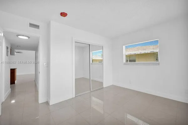 an empty room with windows and entrance