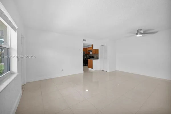 a view of empty room with furniture and window