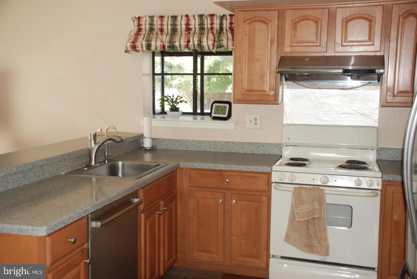 28 Knox Court Chesterbrook, PA 19087 - Photo 7 of 16 a kitchen with stainless steel appliances granite countertop a sink a stove and a microwave
