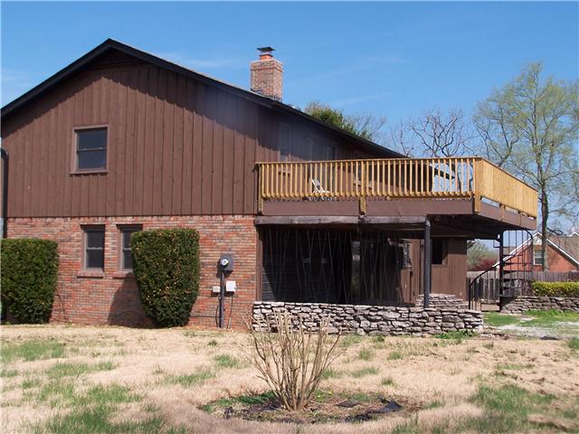 2407 Zion Road Columbia, TN 38401 - Photo 2 of 20 side view with garage and back balcony with deck railing