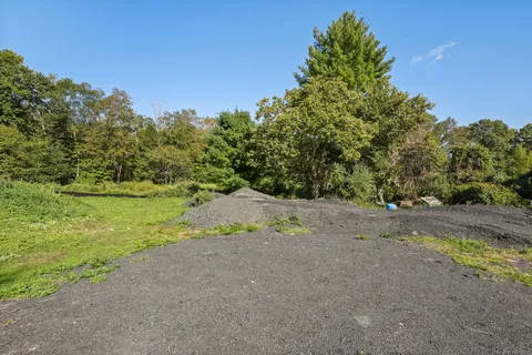 a view of a yard with a tree