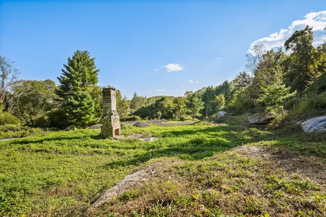 a backyard of a house with a yard and outdoor seating