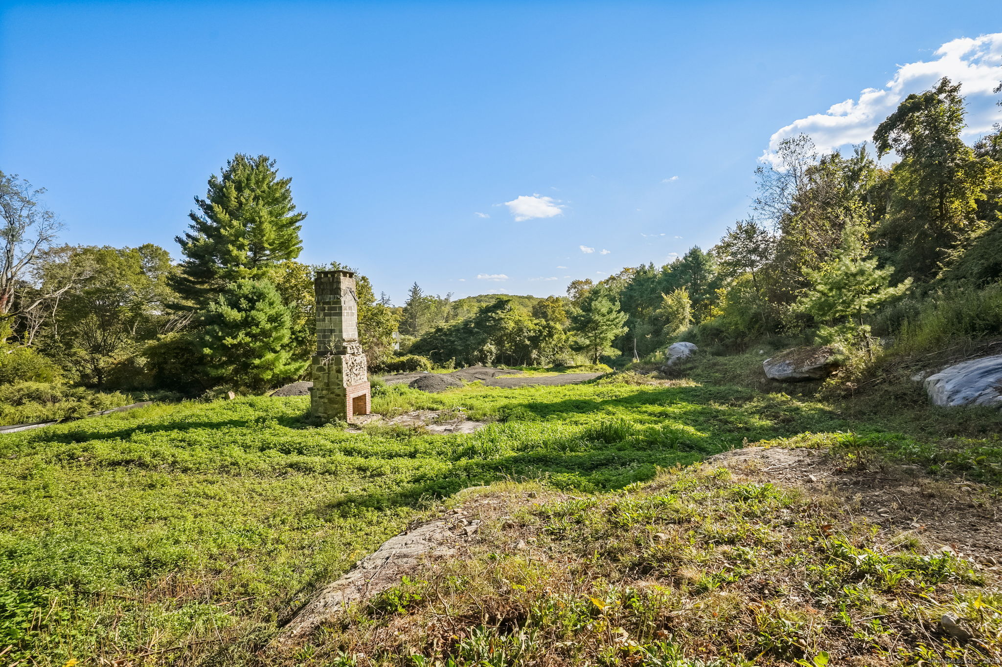 96 Georgetown Road Weston, CT 06883 - Photo 11 of 21 a backyard of a house with a yard and outdoor seating