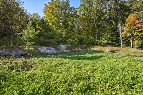 a backyard of a house with a yard and outdoor seating