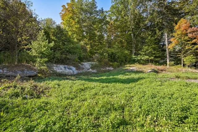 a backyard of a house with a yard and outdoor seating