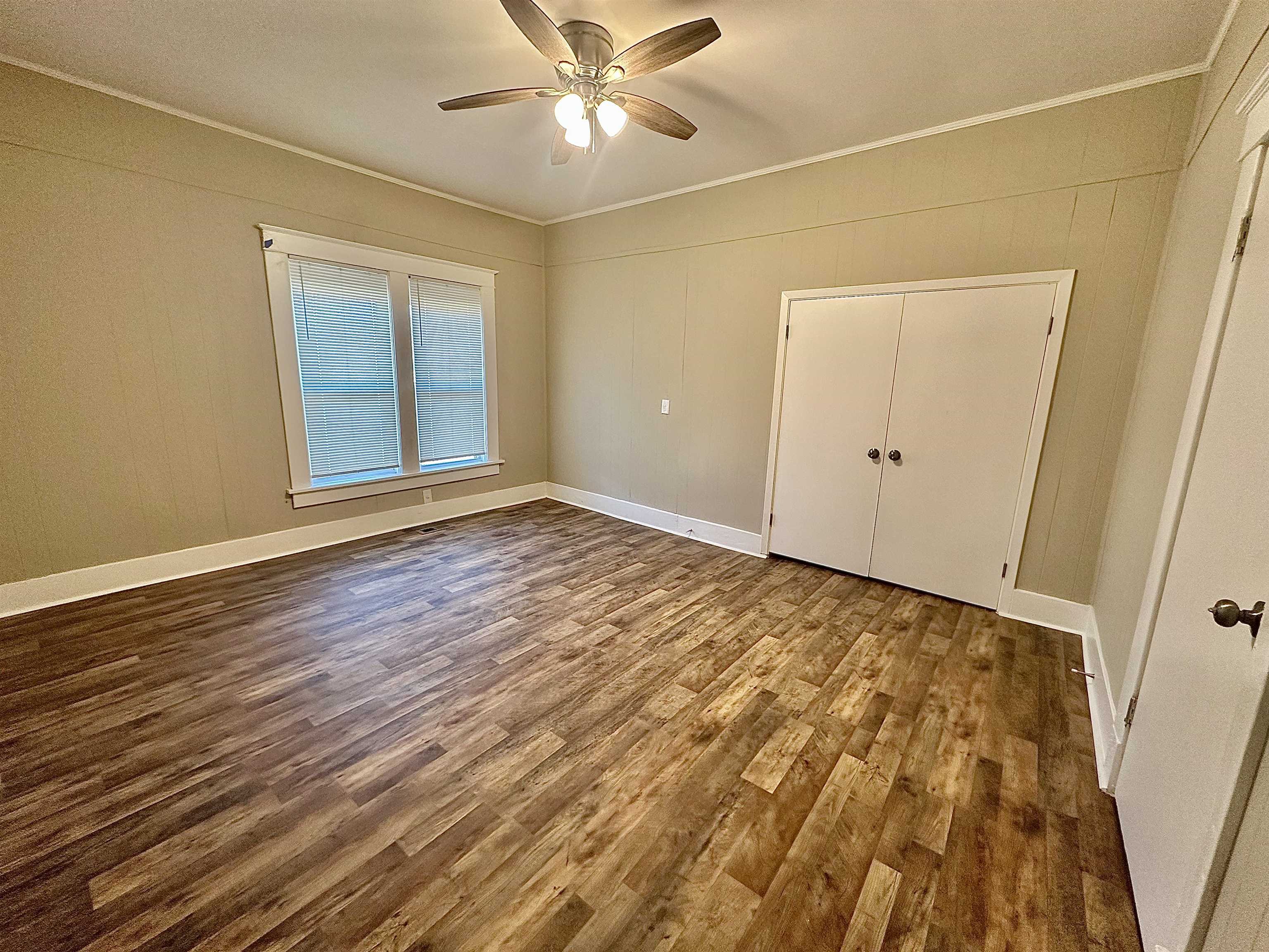 182 South Jefferson Street Ripley, TN 38063 - Photo 11 of 22 a view of an empty room with wooden floor and a window