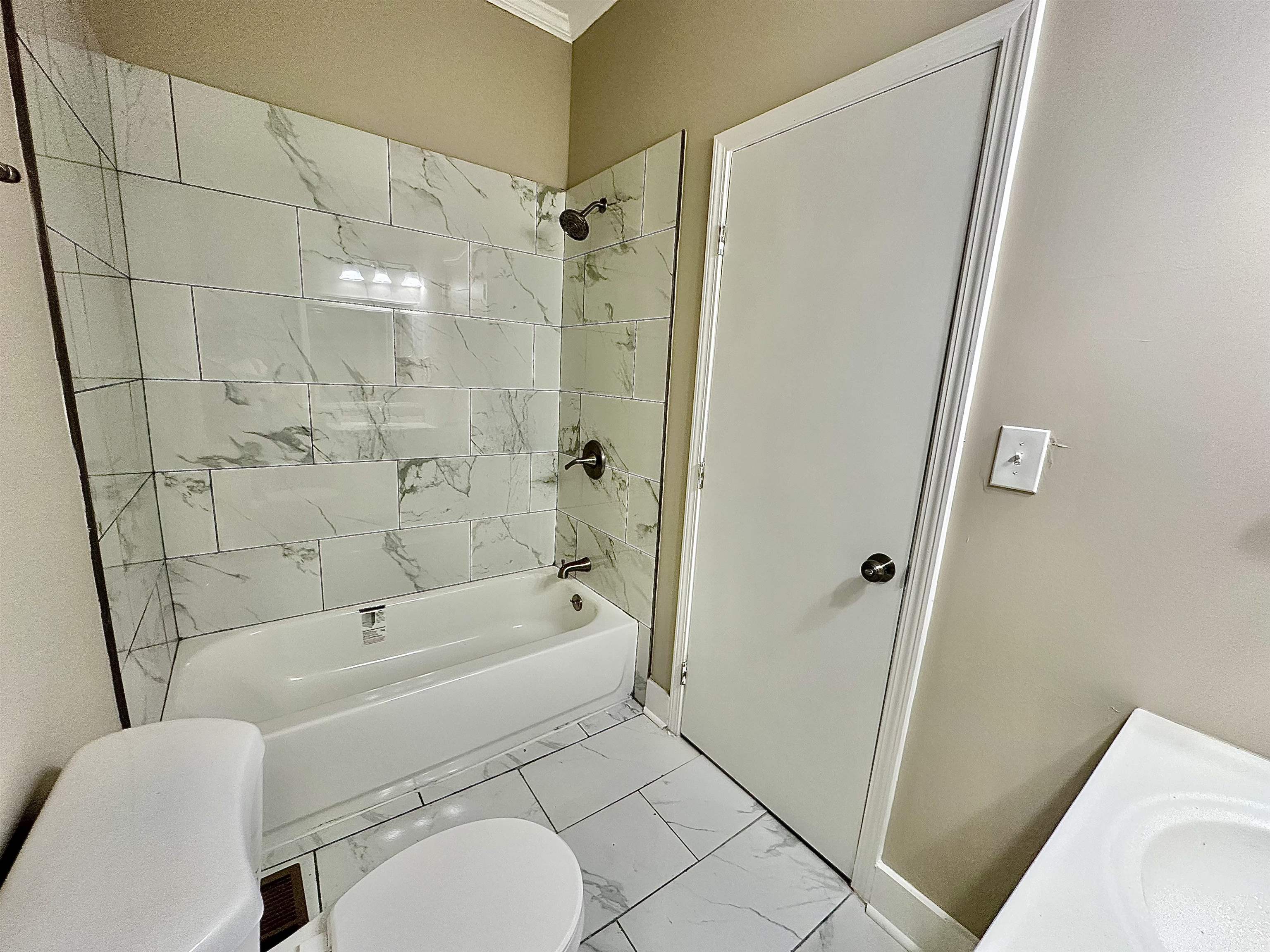 182 South Jefferson Street Ripley, TN 38063 - Photo 14 of 22 a bathroom with a toilet and a bathtub