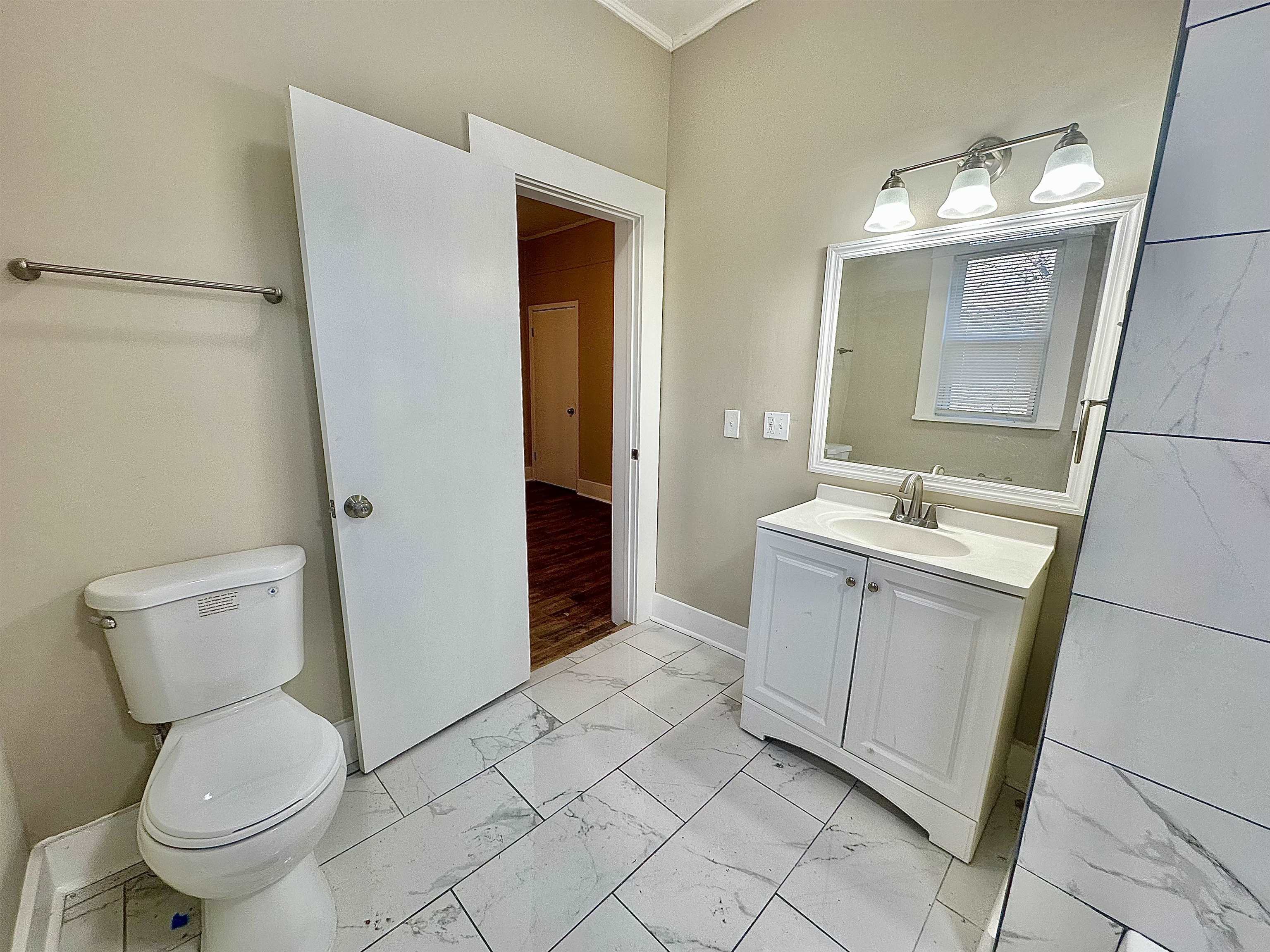 182 South Jefferson Street Ripley, TN 38063 - Photo 18 of 22 a bathroom with a sink toilet and shower