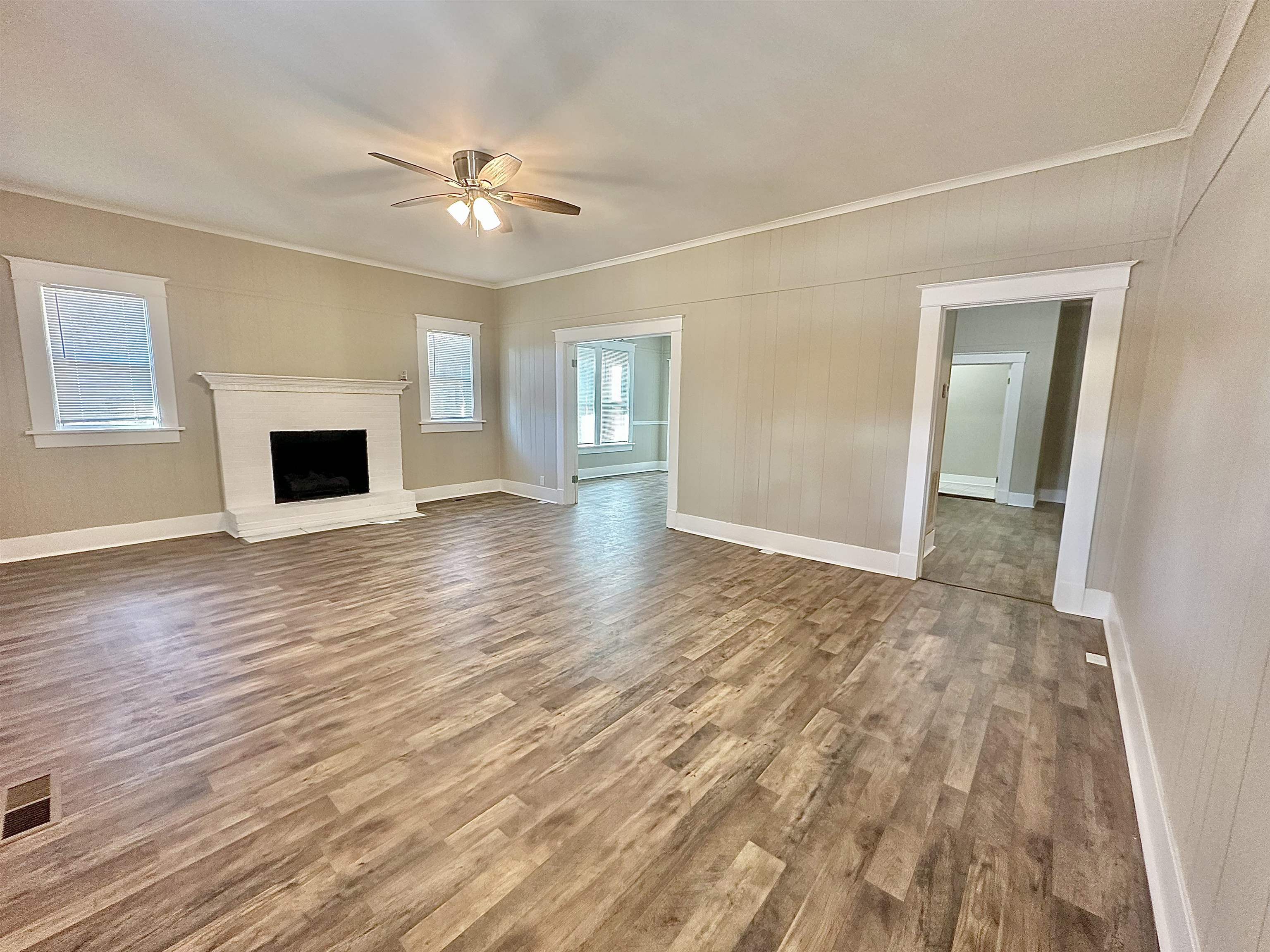 182 South Jefferson Street Ripley, TN 38063 - Photo 3 of 22 a view of a livingroom with wooden floor and a ceiling fan