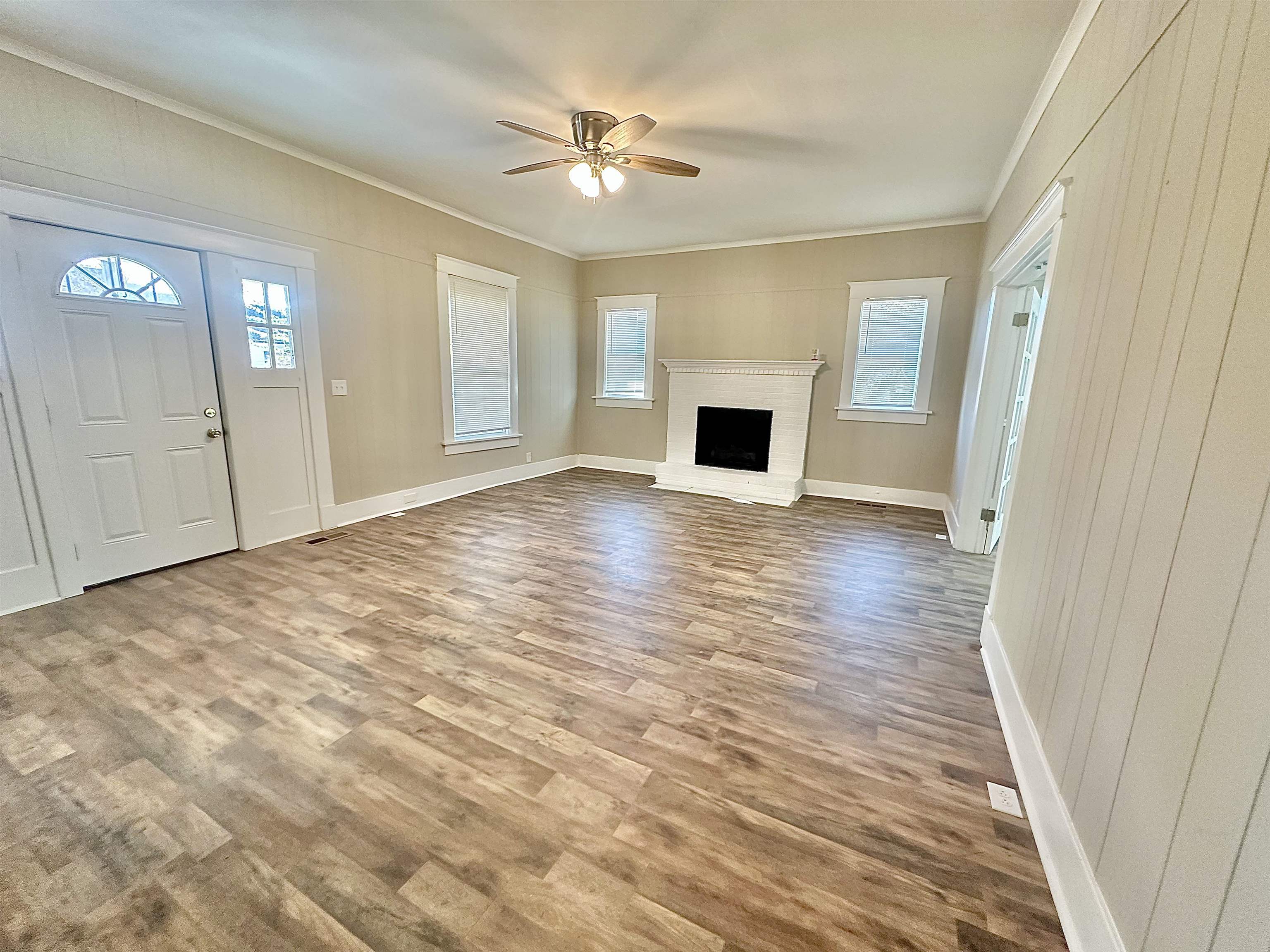 182 South Jefferson Street Ripley, TN 38063 - Photo 5 of 22 a view of empty room with wooden floor and fan