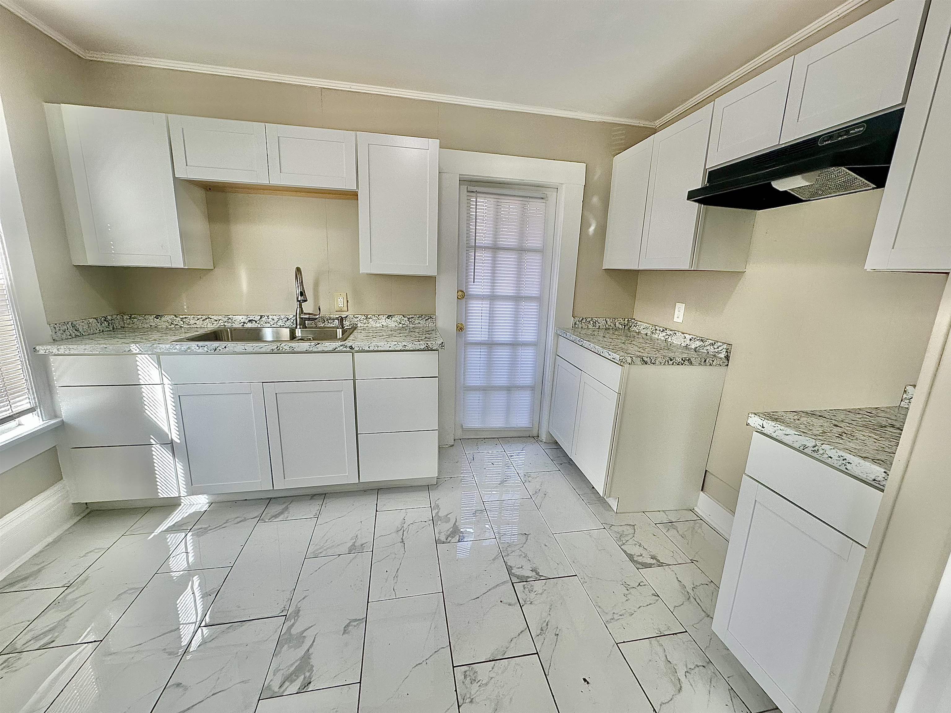 182 South Jefferson Street Ripley, TN 38063 - Photo 7 of 22 a kitchen with a sink a stove and cabinets