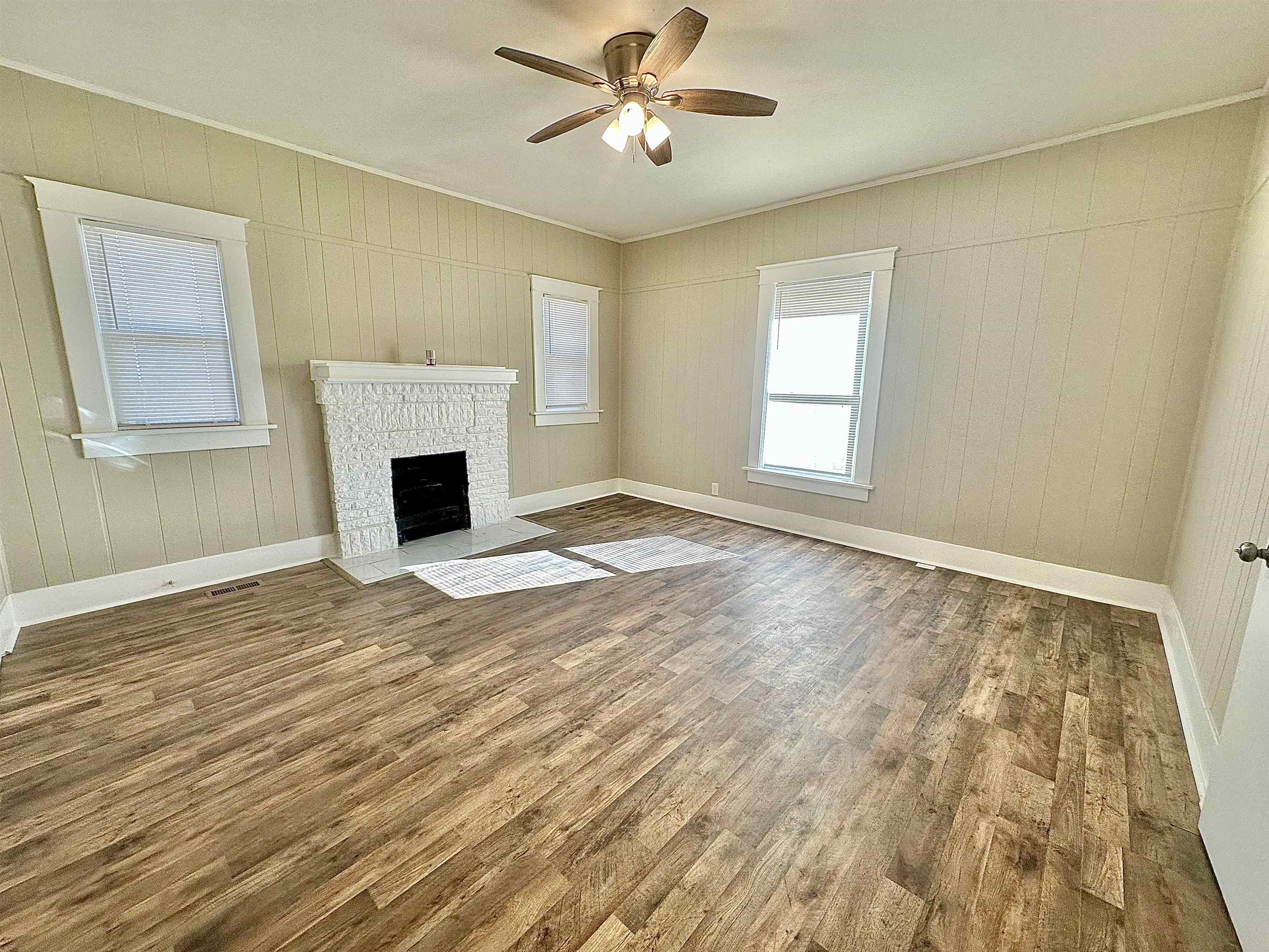182 South Jefferson Street Ripley, TN 38063 - Photo 9 of 22 a view of empty room with fireplace and fan