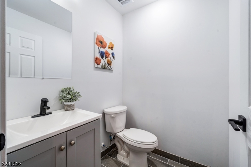 543 13th Avenue Newark, NJ 07103 - Photo 17 of 38 a bathroom with a toilet sink and vanity
