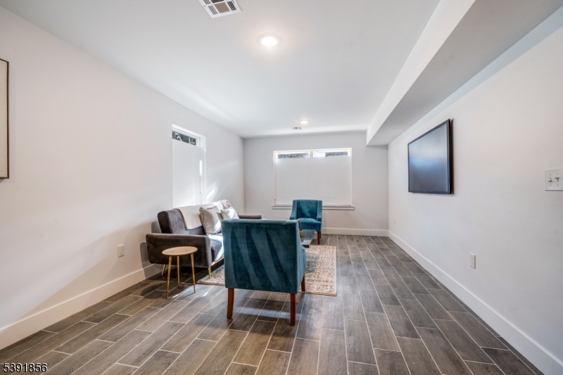 543 13th Avenue Newark, NJ 07103 - Photo 23 of 38 a living room with furniture and a wooden floor