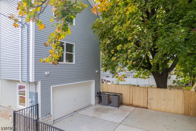 543 13th Avenue Newark, NJ 07103 - Photo 28 of 38 a view of a house with a tree and wooden fence
