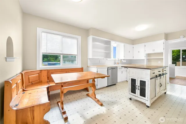 a living room with stainless steel appliances kitchen island granite countertop furniture and a fireplace