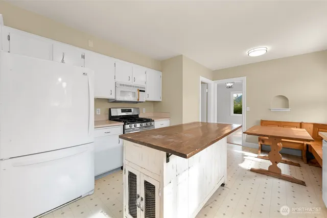 a kitchen with a stove a sink and a refrigerator