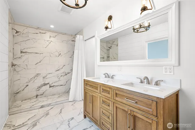 a bathroom with a sink vanity and a mirror