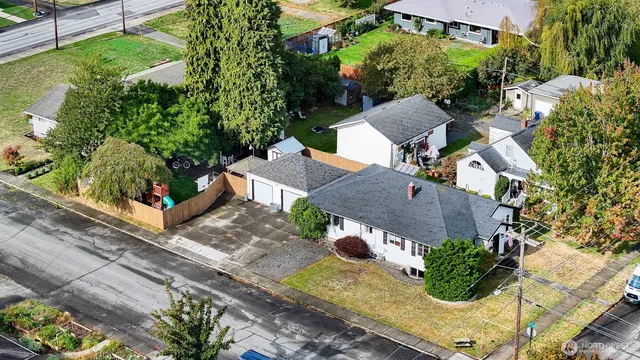 an aerial view of a house with a yard and potted plants