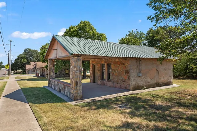 a front view of house with yard outdoor seating and barbeque oven