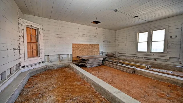 a living room with granite countertop furniture and a flat screen tv