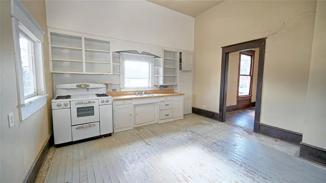 a kitchen with white cabinets and white appliances