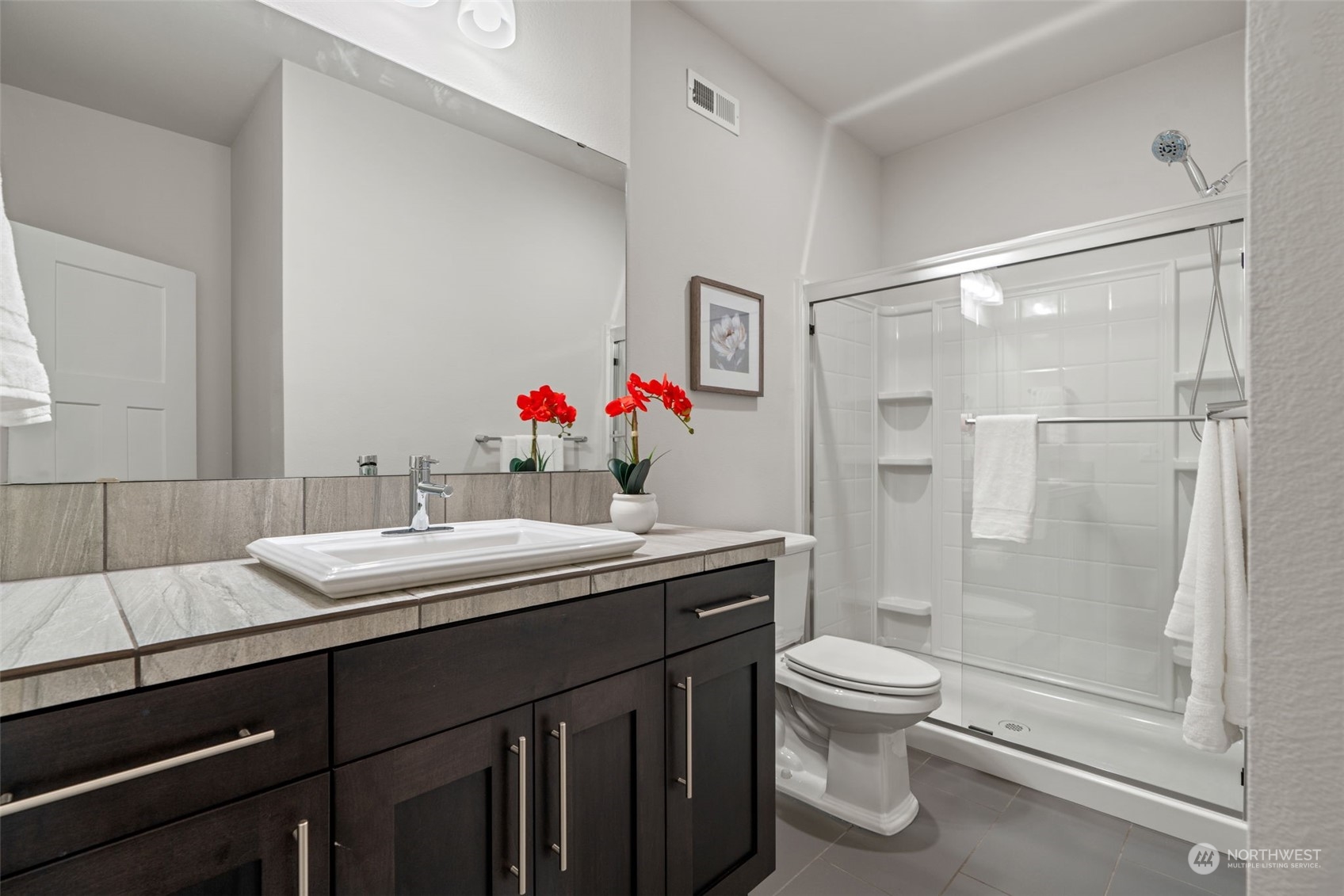 22622 41st Drive Southeast Bothell, WA 98021 - Photo 17 of 34 a bathroom with a sink toilet vanity and shower