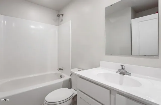 a bathroom with a sink toilet vanity and shower