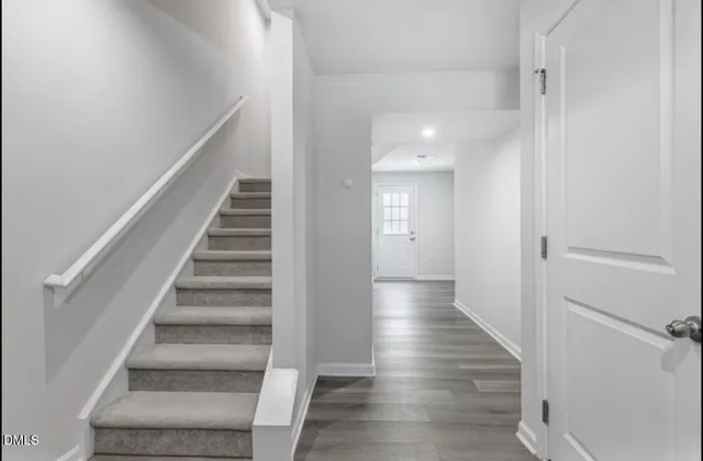 a view of a hallway with wooden floor and entryway