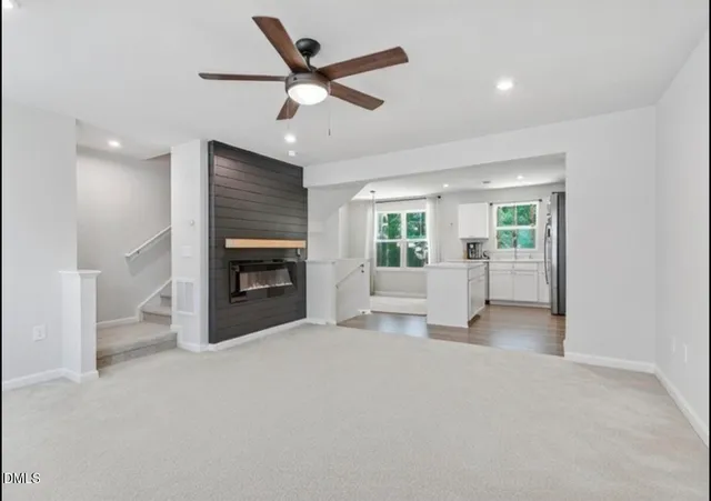 a view of an empty room with a fireplace and a window