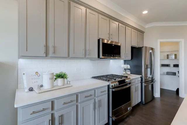 a kitchen with stainless steel appliances granite countertop a stove a refrigerator and a sink
