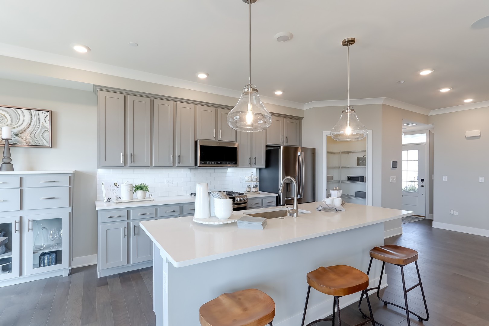 15455 Amelia Circle Lockport, IL 60441 - Photo 8 of 29 a kitchen with kitchen island a sink counter and chairs