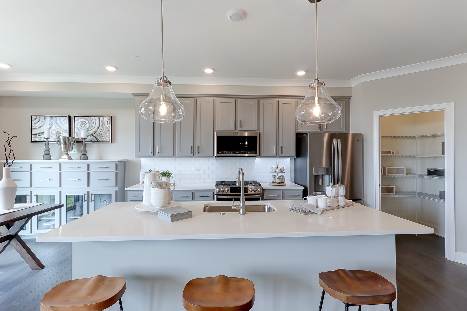 15455 Amelia Circle Lockport, IL 60441 - Photo 9 of 29 a kitchen with kitchen island a sink and a chandelier