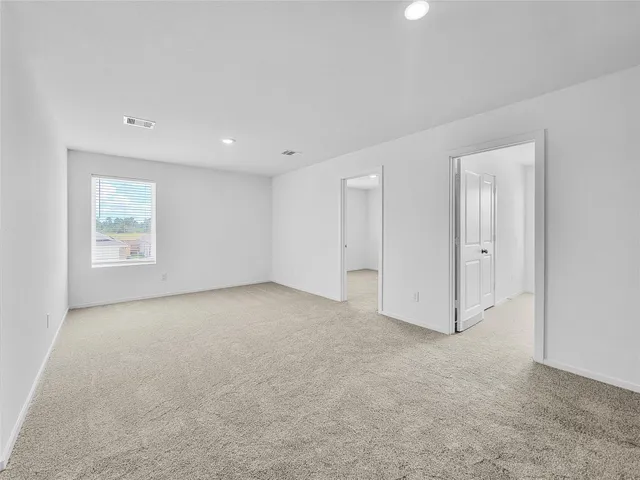 an empty room with a empty space and windows