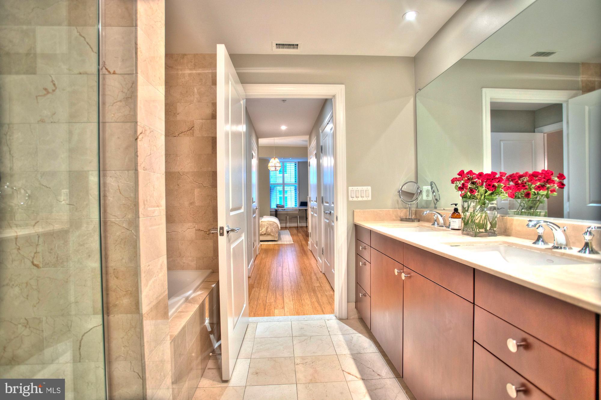 2425 L Street Northwest, Unit 342 Washington, DC 20037 - Photo 13 of 27 a bathroom with a sink vanity and a mirror