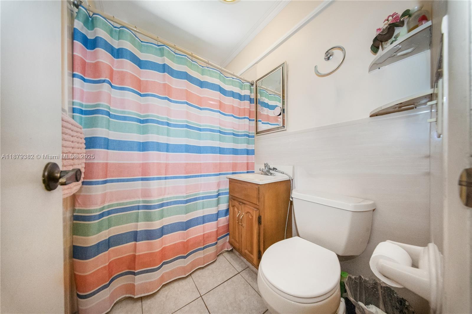 8341 Southwest 27th Lane Miami, FL 33155 - Photo 11 of 20 a white toilet sitting next to a shower curtain