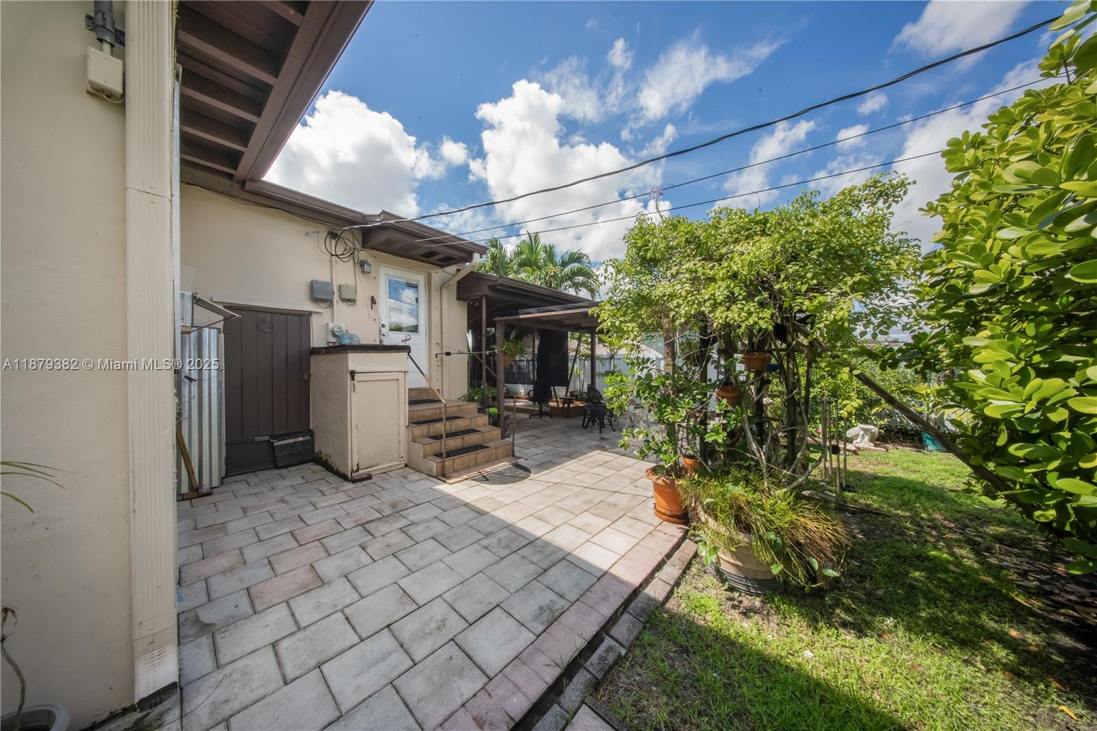8341 Southwest 27th Lane Miami, FL 33155 - Photo 15 of 20 a backyard of a house with table and chairs