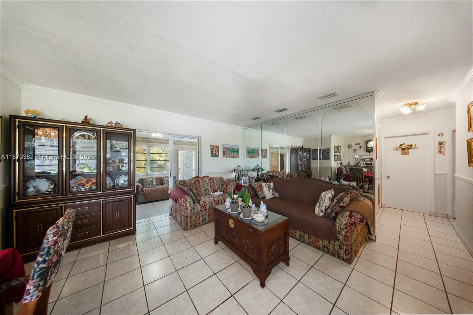 8341 Southwest 27th Lane Miami, FL 33155 - Photo 5 of 20 a living room with furniture and a flat screen tv