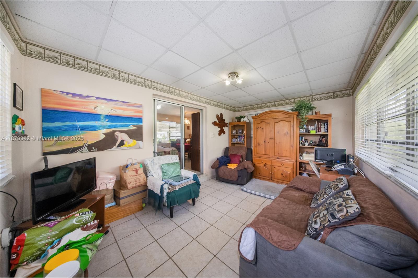 8341 Southwest 27th Lane Miami, FL 33155 - Photo 10 of 20 a living room with furniture a flat screen tv and a couch