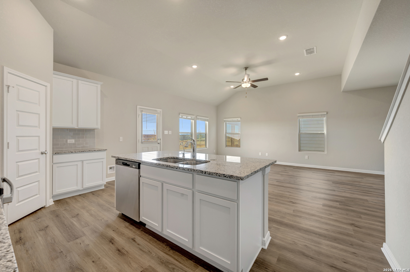 10330 Goodison Drive Converse, TX 78109 - Photo 4 of 42 a kitchen with granite countertop white cabinets and white appliances