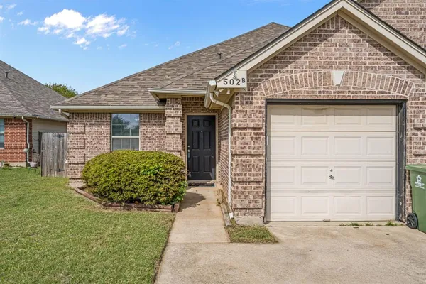front view of a house with a small yard