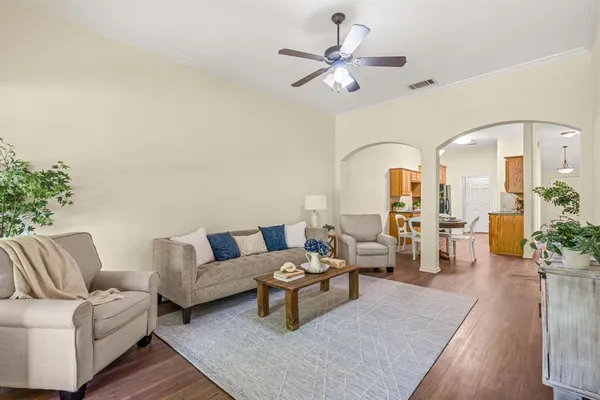 a living room with furniture and wooden floor