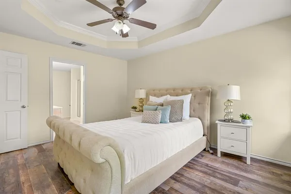 a bedroom with a bed and a chandelier