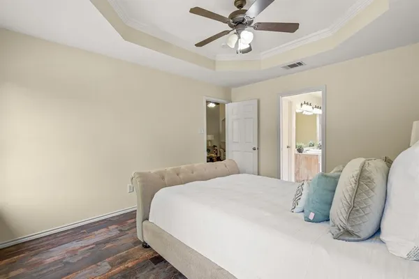 a bedroom with a bed and a chandelier