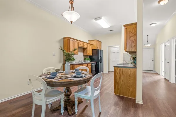a view of a dining room with furniture and wooden floor