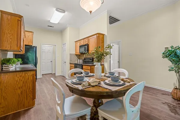 a view of a dining room with furniture and wooden floor