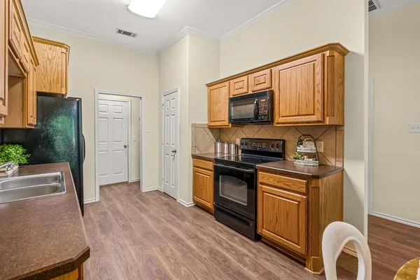 a kitchen with stainless steel appliances granite countertop a stove a sink and a microwave