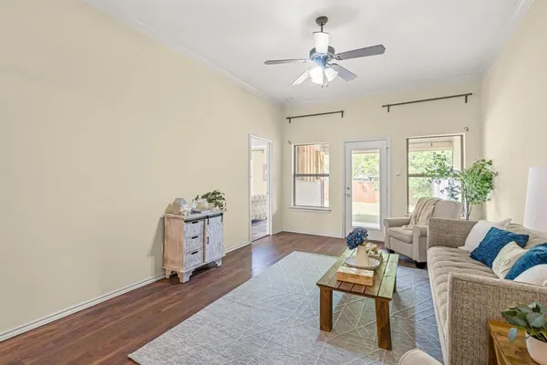 a living room with furniture and wooden floor