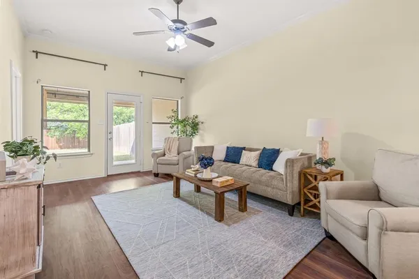 a living room with furniture and wooden floor