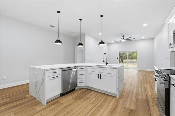 a spacious bathroom with a granite countertop sink mirror and window